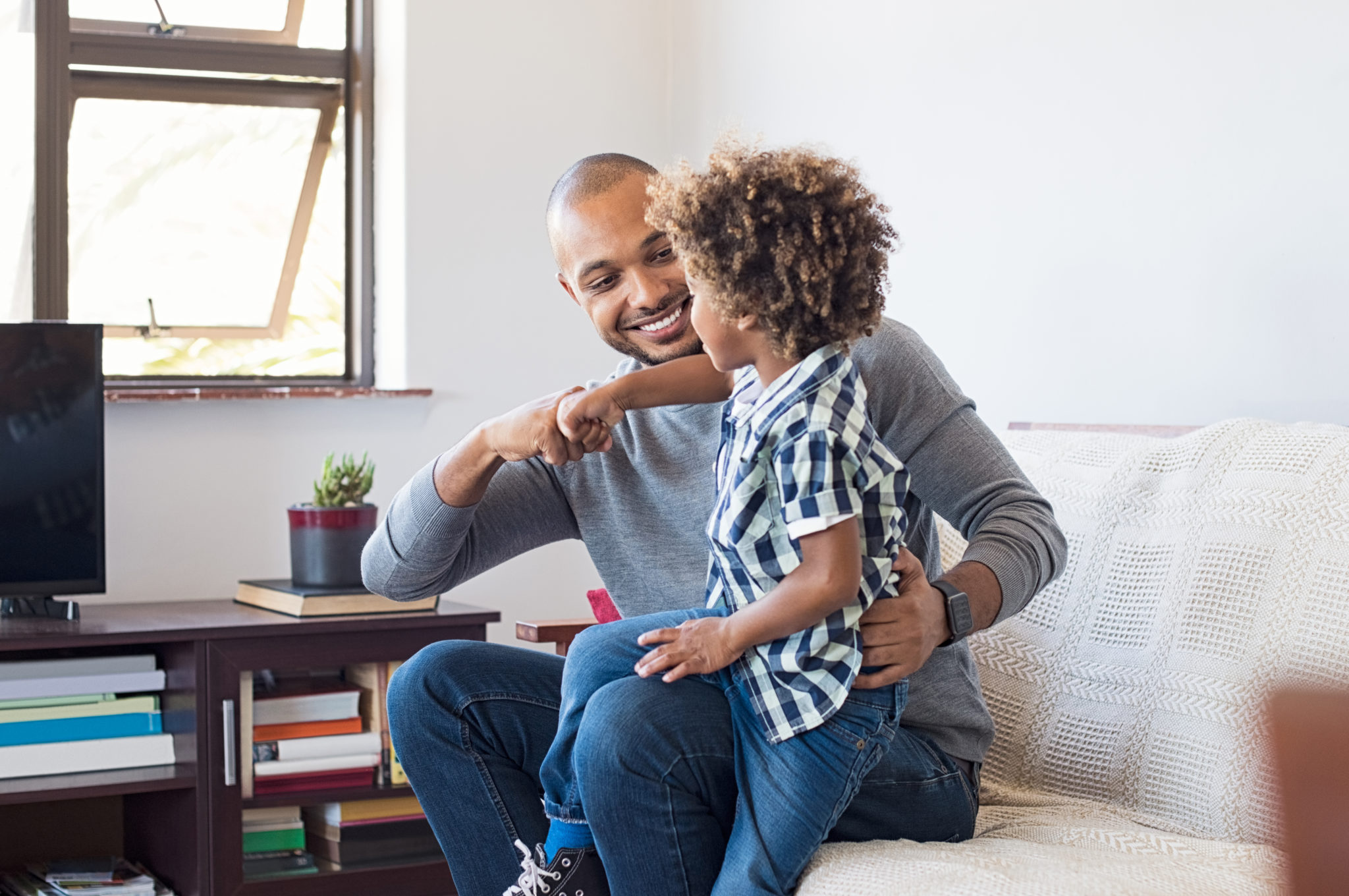 African father and son playing - Child Care Aware of Kansas